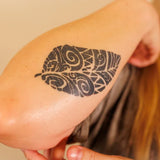 Close-up of a forearm tattoo with a luminous, moisturized finish after applying natural oil