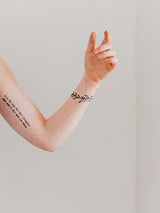 light fine tattoo on lady arm