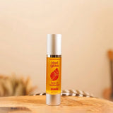 Kiwi Glow's Rosie Face Oil sits in a brown space on a wooden surface with a feather in the background. The bottle is yellow and has the Kiwi Glow Leaf Logo on the center area of the bottle. It reads: "Kiwi Glow... Face Oil Moisterizer... Rosie...net 1.7 fl oz."